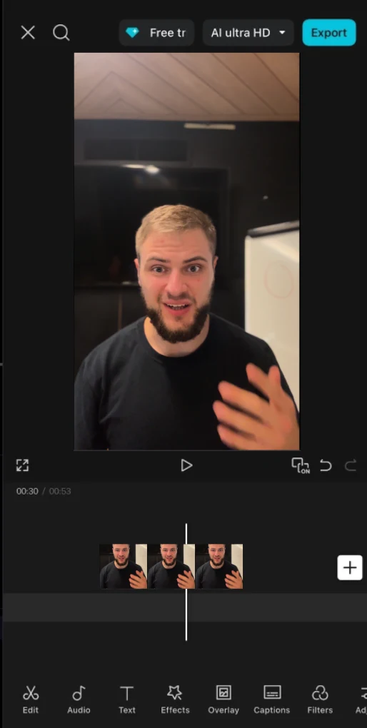CapCut editor on iPhone with a talking-head clip on the timeline and Edit, Audio, Text, Effects, Overlay, Captions, and Filters tools